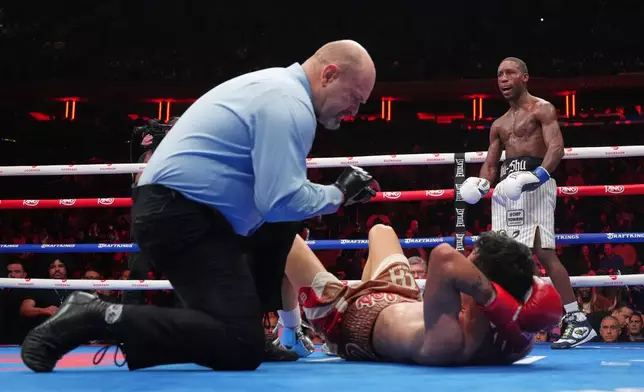 Bruce Carrington celebrates as the referee counts for Carlos Castro during a featherweight title boxing match Saturday, Jan. 31, 2026, in New York. (AP Photo/Frank Franklin II)