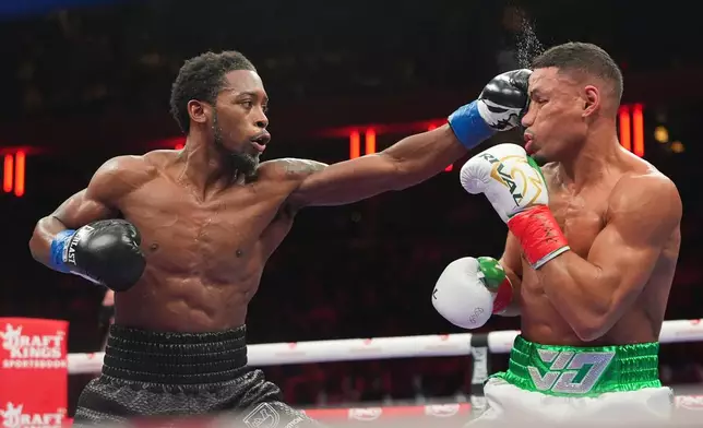 Keyshawn Davis, left, punches Jamaine Ortiz during a super lightweight boxing match Saturday, Jan. 31, 2026, in New York. (AP Photo/Frank Franklin II)