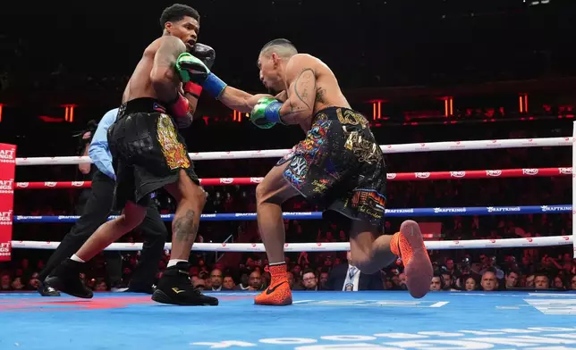 Shadur Stevenson, left, fights Teofimo Lopez during a super lightweight title boxing match Sunday, Feb. 1, 2026, in New York. (AP Photo/Frank Franklin II)