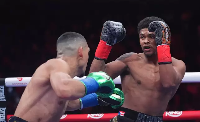 Shadur Stevenson, right, fights Teofimo Lopez during a super lightweight title boxing match Sunday, Feb. 1, 2026, in New York. (AP Photo/Frank Franklin II)