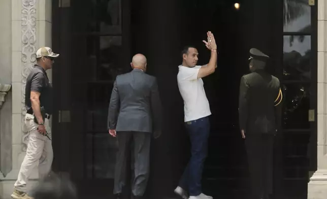 Peru's President Jose Jeri applauds after attending the changing of the guard at the government palace in Lima, Peru, Tuesday, Feb. 17, 2026. (AP Photo/Gerardo Marin)