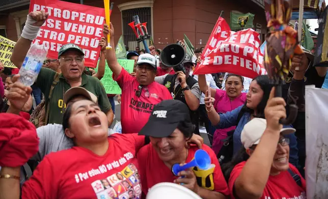 Demonstrators celebrate after Congress voted to remove interim President Jose Jeri as he faces corruption allegations outside the site where lawmakers met in Lima, Peru, Tuesday, Feb. 17, 2026. (AP Photo/Guadalupe Pardo)