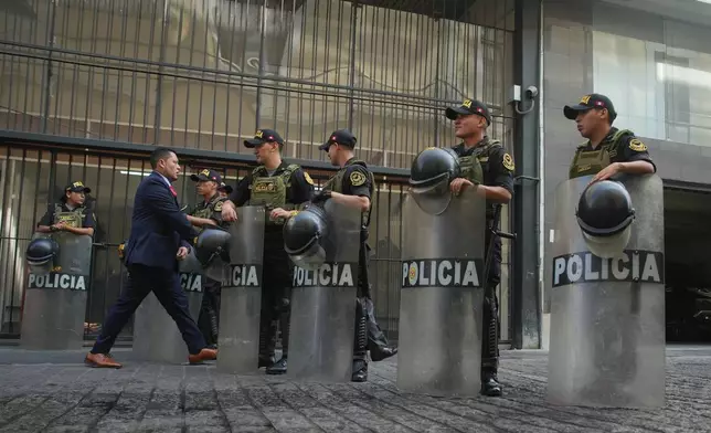 Police stand guard outside the location where lawmakers are debating the removal of Peruvian President Jose Jeri in Lima, Peru, Tuesday, Feb. 17, 2026. (AP Photo/Guadalupe Pardo)