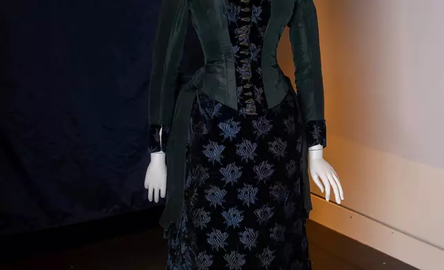 A vintage walking dress is held in preparation for The Metropolitan Museum of Art's spring exhibition, "Costume Art," on Thursday, Feb. 12, 2026, in New York. (Photo by Charles Sykes/Invision/AP)