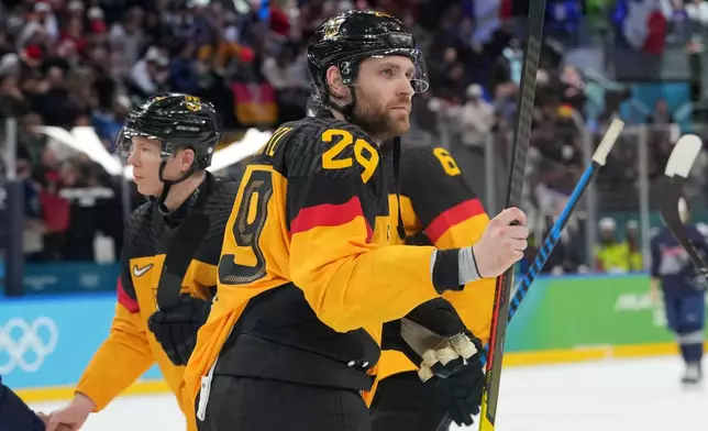 Germany's Leon Draisaitl (29) leaves the ice following a win over France in a men's ice hockey qualification playoff game at the 2026 Winter Olympics, in Milan, Italy, Tuesday, Feb. 17, 2026. (AP Photo/Carolyn Kaster)