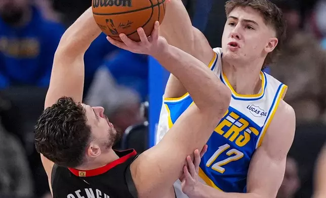 Indiana Pacers guard Johnny Furphy (12) blocks the shot of Houston Rockets center Alperen Sengun (28) during the first half of an NBA basketball game in Indianapolis, Monday, Feb. 2, 2026. (AP Photo/Michael Conroy)