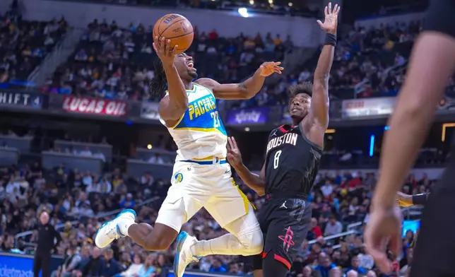 Indiana Pacers guard/forward Aaron Nesmith (23) shoots over Houston Rockets forward Jae'sean Tate (8) during the first half of an NBA basketball game in Indianapolis, Monday, Feb. 2, 2026. (AP Photo/Michael Conroy)