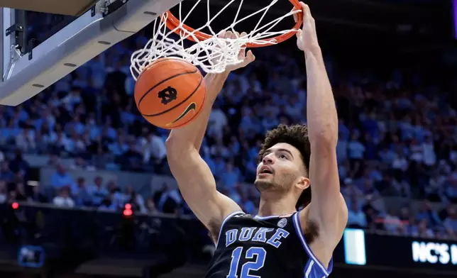 FILE - Duke forward Cameron Boozer dunks during the second half in an NCAA college basketball game against North Carolina, Saturday, Feb. 7, 2026, in Chapel Hill, N.C. (AP Photo/Chris Seward, File)