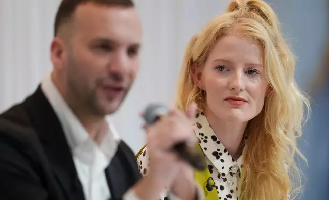 Green Party newly elected Member of Parliament Hannah Spencer looks on as party leader Zack Polanski speaks at a press conference after her win in the Gorton and Denton by-election, in Manchester, England, Friday, Feb. 27, 2026. (AP Photo/Jon Super)