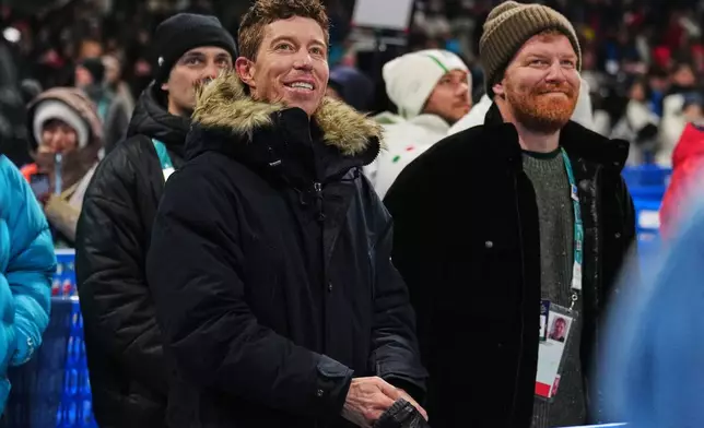 Shaun White watches competition during the men's snowboarding halfpipe qualifications at the 2026 Winter Olympics, in Livigno, Italy, Wednesday, Feb. 11, 2026. (AP Photo/Abbie Parr)