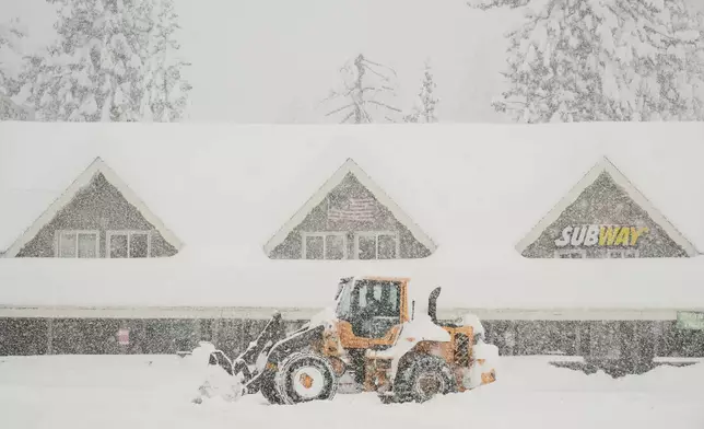 Snow is plowed in front of businesses during a snow storm Thursday, Feb. 19, 2026, in Soda Springs, Calif. (AP Photo/Godofredo A. Vásquez)