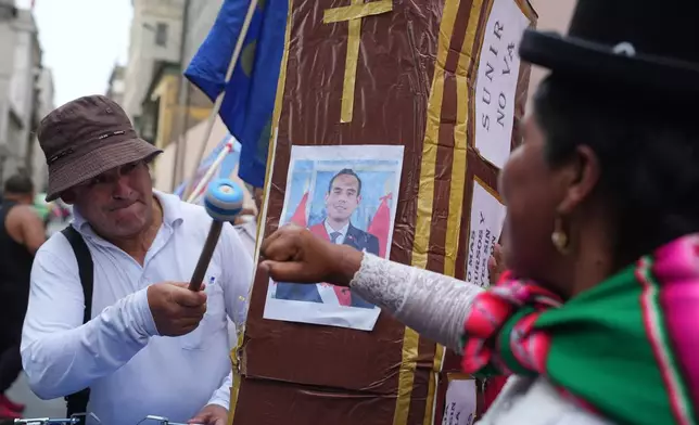 Demonstrators celebrate after learning Congress voted to remove interim President Jose Jeri as he faces corruption allegations, outside the site where lawmakers met in Lima, Peru, Tuesday, Feb. 17, 2026. (AP Photo/Guadalupe Pardo)