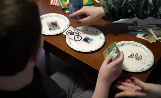 Ronan Murphy works on a sorting problem during an applied behavior analysis after school in his home in Ayer, Mass., on Friday, Jan. 16, 2026. (AP Photo/Shelby Lum)