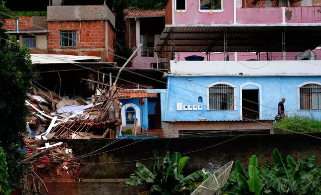 A home is collapsed due to heavy rains and flooding in the Parque Burnier neighborhood of Juiz de Fora, Minas Gerais state, Brazil, Wednesday, Feb. 25, 2026. (AP Photo/Silvia Izquierdo)