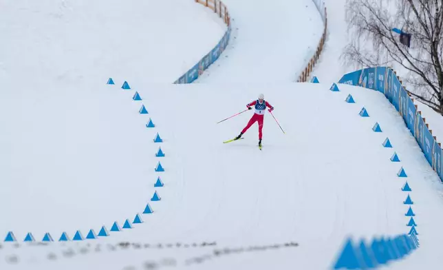 Johannes Hoesflot Klaebo, of Norway, races to the finish line to win the gold medal in the cross-country skiing men's sprint classic at the 2026 Winter Olympics, in Tesero, Italy, Tuesday, Feb. 10, 2026. (AP Photo/Evgeniy Maloletka)