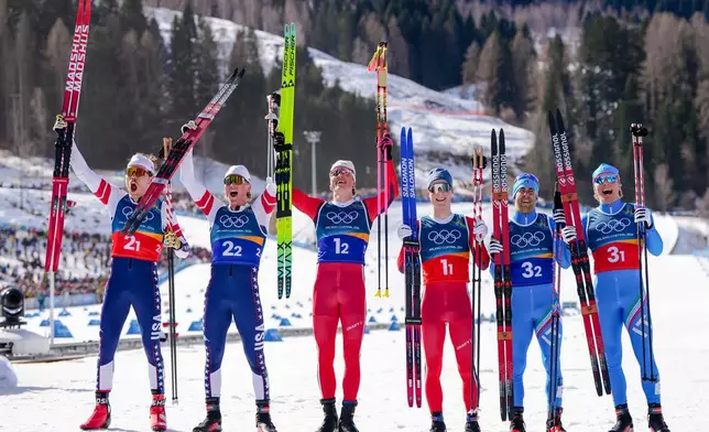 Silver medalists Ben Ogden and Gus Schumacher, of the United States, gold medalists Johannes Hoesflot Klaebo and Einar Hedegart, of Norway, and bronze medalists Federico Pellegrino and Elia Barp, of Italy, pose after the cross-country skiing men's team sprint free at the 2026 Winter Olympics, in Tesero, Italy, Wednesday, Feb. 18, 2026. (AP Photo/Kirsty Wigglesworth)