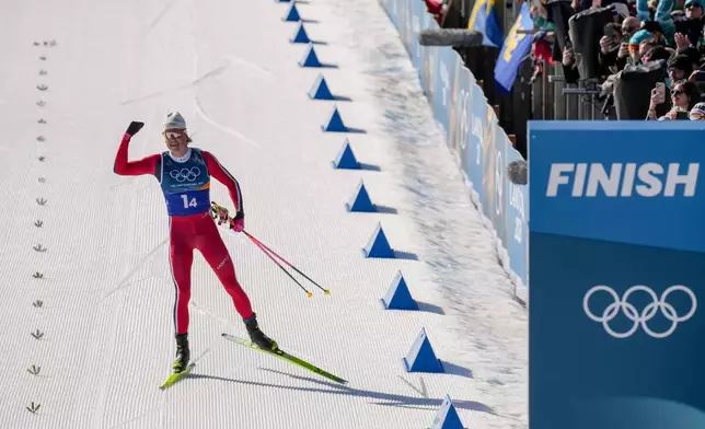 Johannes Hoesflot Klaebo, of Norway, approaches the finish line to win the gold medal in the cross country skiing men's 4 x 7.5km relay at the 2026 Winter Olympics, in Tesero, Italy, Sunday, Feb. 15, 2026. (AP Photo/Evgeniy Maloletka)