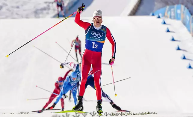 Johannes Hoesflot Klaebo, of Norway, approaches the finish line to win the gold medal in the cross-country skiing men's team sprint free at the 2026 Winter Olympics, in Tesero, Italy, Wednesday, Feb. 18, 2026. (AP Photo/Kirsty Wigglesworth)
