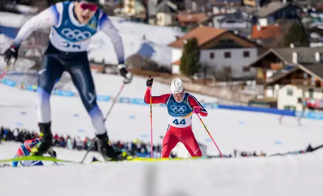 Johannes Hoesflot Klaebo, right, of Norway, competes in the cross country skiing men's 10km interval start free at the 2026 Winter Olympics, in Tesero, Italy, Friday, Feb. 13, 2026. (AP Photo/Kirsty Wigglesworth)