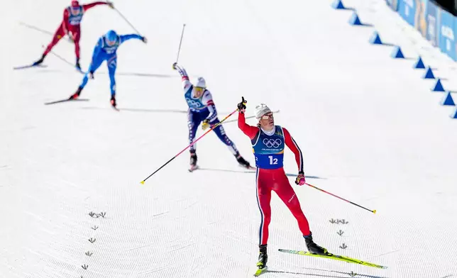 Johannes Hoesflot Klaebo, of Norway, approaches the finish line to win the gold medal in the cross-country skiing men's team sprint free at the 2026 Winter Olympics, in Tesero, Italy, Wednesday, Feb. 18, 2026. (AP Photo/Matthias Schrader)