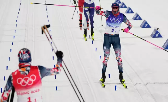 FILE- Johannes Hoesflot Klaebo, of Norway, right, celebrates as he nears the finish with Erik Valnes, of Norway, left, during the men's team sprint classic cross-country skiing competition at the 2022 Winter Olympics, Feb. 16, 2022, in Zhangjiakou, China. (AP Photo/Alessandra Tarantino, File)