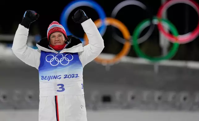 FILE - Gold medal finisher Johannes Hoesflot Klaebo, of Norway, celebrates during a venue ceremony after the men's sprint free cross-country skiing competition at the 2022 Winter Olympics, Feb. 8, 2022, in Zhangjiakou, China. (AP Photo/Alessandra Tarantino, File)