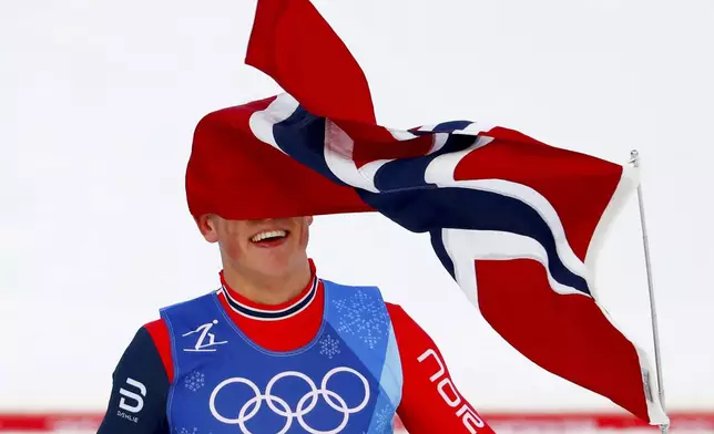 FILE - Johannes Hoesflot Klaebo, of Norway, celebrates after winning the gold medal in the men's 4 x 10km relay cross-country skiing competition at the 2018 Winter Olympics in Pyeongchang, South Korea, Feb. 18, 2018. (AP Photo/Matthias Schrader, File)