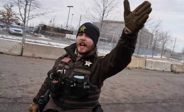A sheriff's deputy yells at counterprotesters demonstrating against Jake Lang on Saturday, Feb. 7, 2026, in Minneapolis. (AP Photo/Ryan Murphy)
