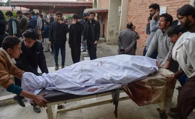 Relatives and volunteers transport a victim of bomb explosion in a Shiite mosque, from at a hospital in Islamabad, Pakistan, Friday, Feb. 6, 2026. (AP Photo/M.A Sheikh)