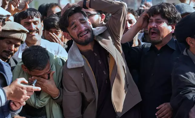People mourn over coffins of their relatives, who were killed in Friday's suicide bombing inside a Shiite mosque, in Islamabad, Pakistan, Saturday, Feb. 7, 2026. (AP Photo/Anjum Naveed)