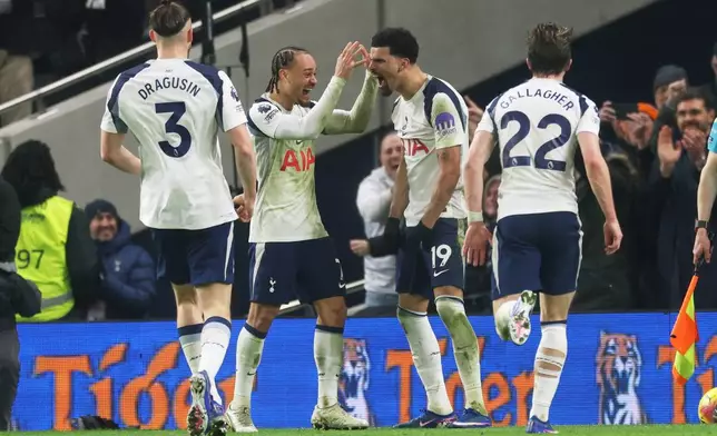 Tottenham's Dominic Solanke (19) is congratulated after scoring his side's 2nd goal during the English Premier League soccer match between Tottenham Hotspur and Manchester City in London, Sunday, Feb. 1, 2026. (AP Photo/Richard Pelham)