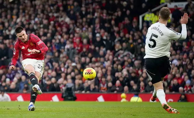 Manchester United's Benjamin Sesko, left, scores his side's third goal during the English Premier League soccer match between Manchester United and Fulham in Manchester, England, Sunday, Feb. 1, 2026. (AP Photo/Dave Thompson)