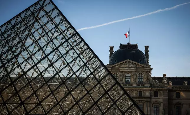 The french flag flutters on the Louvre museum in Paris, Wednesday Feb. 25, 2026. (AP Photo/Thomas Padilla)