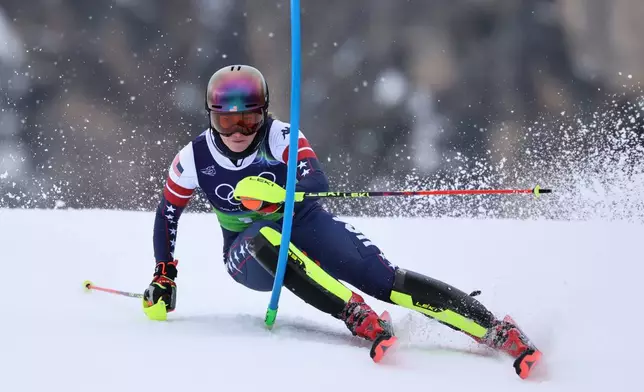 United States' Mikaela Shiffrin speeds down the course during an alpine ski, slalom portion of a women's team combined race, at the 2026 Winter Olympics, in Cortina d'Ampezzo, Italy, Tuesday, Feb. 10, 2026. (AP Photo/Marco Trovati)