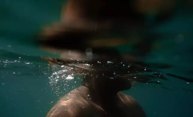 Fisherman Pancho Contreras dives into the sea to observe corals near Los Arrecifes, Mexico, Oct. 26, 2025. (AP Photo/Felix Marquez)