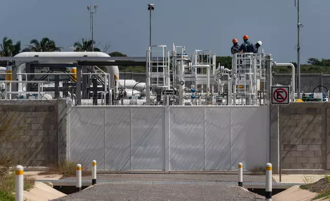 Workers are visible at a compressor station for the Southeast Gateway natural gas pipeline operates in Coatzacoalcos, Mexico, Oct. 28, 2025. (AP Photo/Felix Marquez)