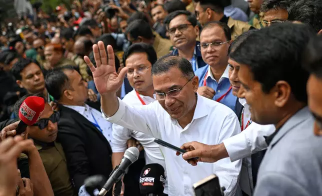 Bangladesh Nationalist Party Chairperson Tarique Rahman waves as he comes out after casting his vote during the national parliamentary elections in Dhaka, Bangladesh, Thursday, Feb. 12, 2026. (AP Photo/Mahmud Hossain Opu)