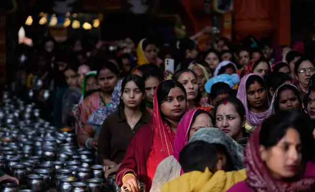 Hindu devotees queue inside a temple to offer prayers during Shivratri, the sacred night dedicated to Lord Shiva in Jammu, India, Sunday, Feb. 15, 2026. (AP Photo/Channi Anand)
