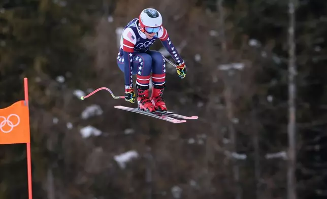 United States' Breezy Johnson speeds down the course during an alpine ski, women's downhill official training, at the 2026 Winter Olympics, in Cortina d'Ampezzo, Italy, Friday, Feb. 6, 2026. (AP Photo/Marco Trovati)
