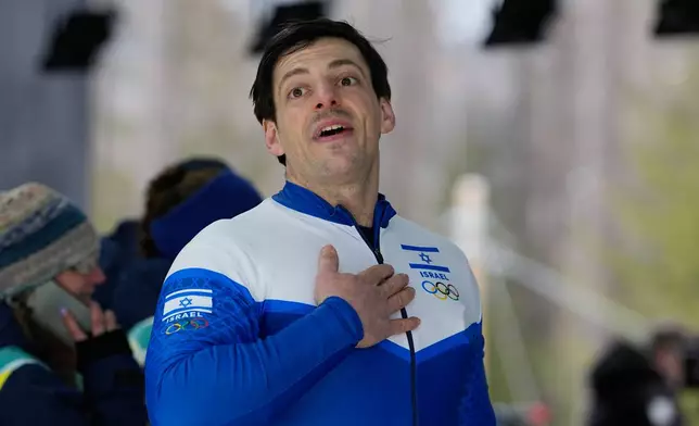 Israel's Adam Edelman salutes public at the end of a two man bobsled run at the 2026 Winter Olympics, in Cortina d'Ampezzo, Italy, Monday, Feb. 16, 2026. (AP Photo/Alessandra Tarantino)