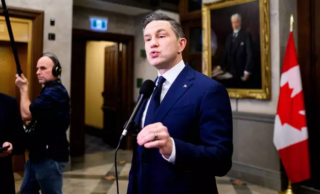 FILE - Conservative Leader Pierre Poilievre speaks in the foyer of the House of Commons on Parliament Hill in Ottawa, Thursday, Dec. 11, 2025. (Spencer Colby/The Canadian Press via AP, File