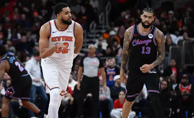 New York Knicks' Karl-Anthony Towns (32) celebrates after making a 3-point basket while Chicago Bulls' Nick Richards (13) reacts during the second half of an NBA basketball game, Sunday, Feb. 22, 2026, in Chicago. (AP Photo/Paul Beaty)