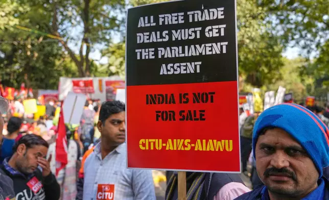 Members of trade unions hold banners during a nationwide strike to protest an interim trade deal with the United States, saying the agreement undermines the interests of farmers, small businesses and workers in New Delhi, India, Thursday, Feb. 12, 2026. (AP Photo/Manish Swarup)