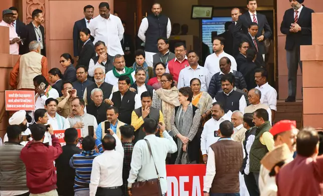 Senior Congress party leader Priyanka Gandhi Vadra, center, hands crossed, joins other members of the opposition during a protest against the India-US trade deal outside the Parliament in New Delhi, India, Thursday, Feb. 12, 2026. (AP Photo)