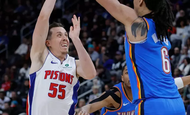 Detroit Pistons forward Duncan Robinson (55) passes the ball against Oklahoma City Thunder forward Jaylin Williams (6) for a Pistons dunk during the first half of an NBA basketball game, Wednesday, Feb. 25, 2026, in Detroit. (AP Photo/Duane Burleson)