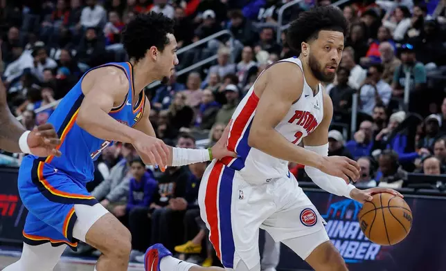 Detroit Pistons guard Cade Cunningham drives to the basket against Oklahoma City Thunder guard Jared McCain during the first half of an NBA basketball game, Wednesday, Feb. 25, 2026, in Detroit. (AP Photo/Duane Burleson)