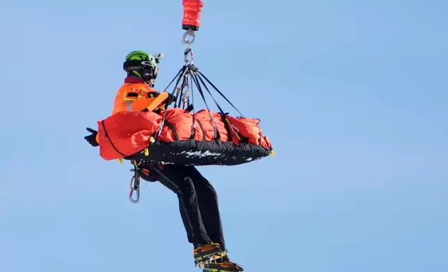 United States' Lindsey Vonn is airlifted away after a crash during an alpine ski women's downhill race, at the 2026 Winter Olympics, in Cortina d'Ampezzo, Italy, Sunday, Feb. 8, 2026. (AP Photo/Jacquelyn Martin)
