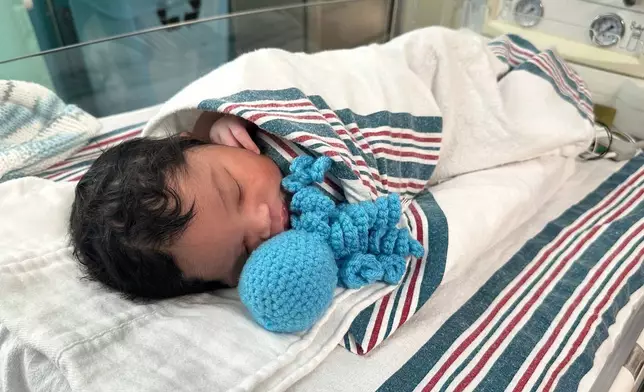 Newborn Tayshaun Nelms Jr. rests with an amigurumi octopi at the Children's Hospital of Michigan Neonatal Intensive Care Unit at DMC Hutzel Women's Hospital in Detroit, Thursday, Feb. 26, 2026. (AP Photo/Corey Williams)