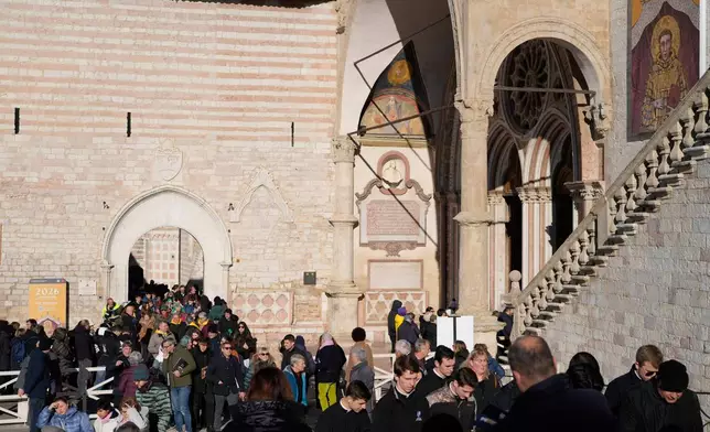 Pilgrims leave after they honored the bones of St. Francis during the first public display inside the St. Francis Basilica, marking the 800th anniversary of the saint's death, in Assisi, Italy, Sunday, Feb. 22, 2026.(AP Photo/Gregorio Borgia)