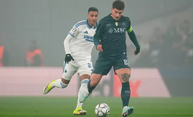 Napoli's Giovanni Di Lorenzo, right, and FC Copenhagen's Elias Achouri battle for the ball during the Champions League group stage soccer match between FC Copenhagen and Napoli in Copenhagen, Tuesday, Jan. 20, 2026. (Liselotte Sabroe/Ritzau Scanpix via AP)